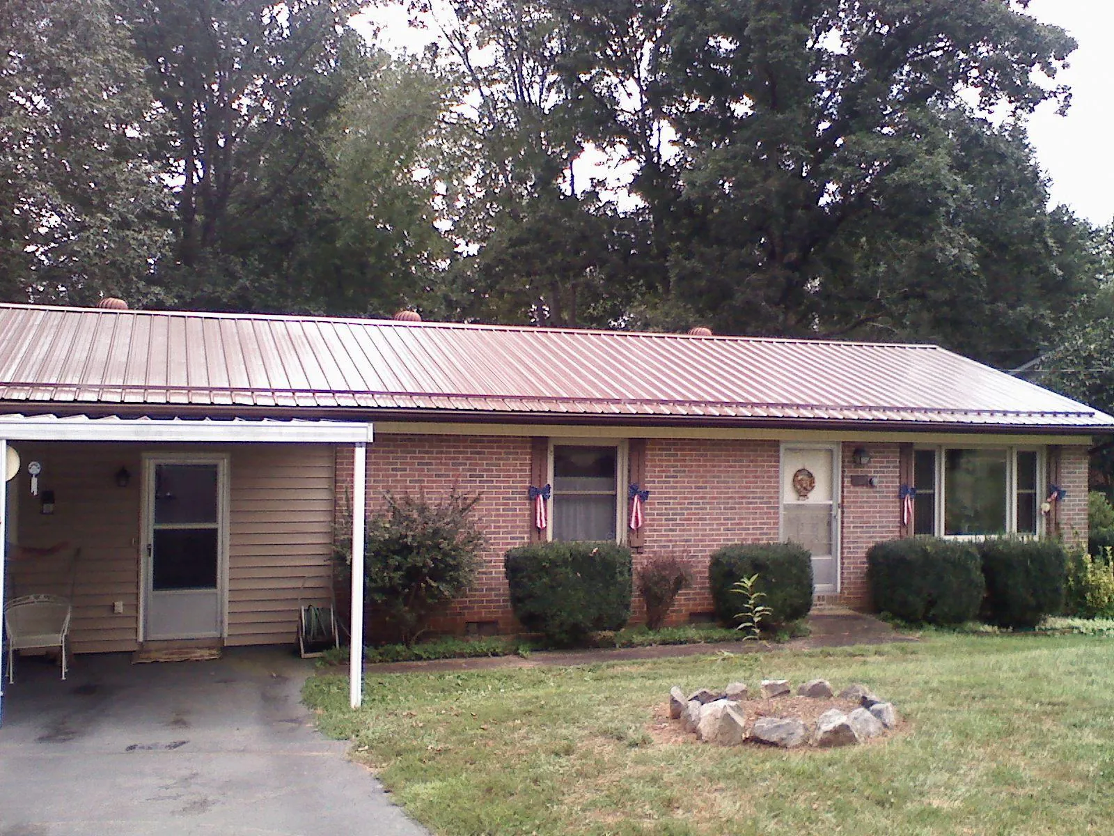 Bronze metal roof and carport on a brick ranch home — Roof Repair work by our crew in Searchlight