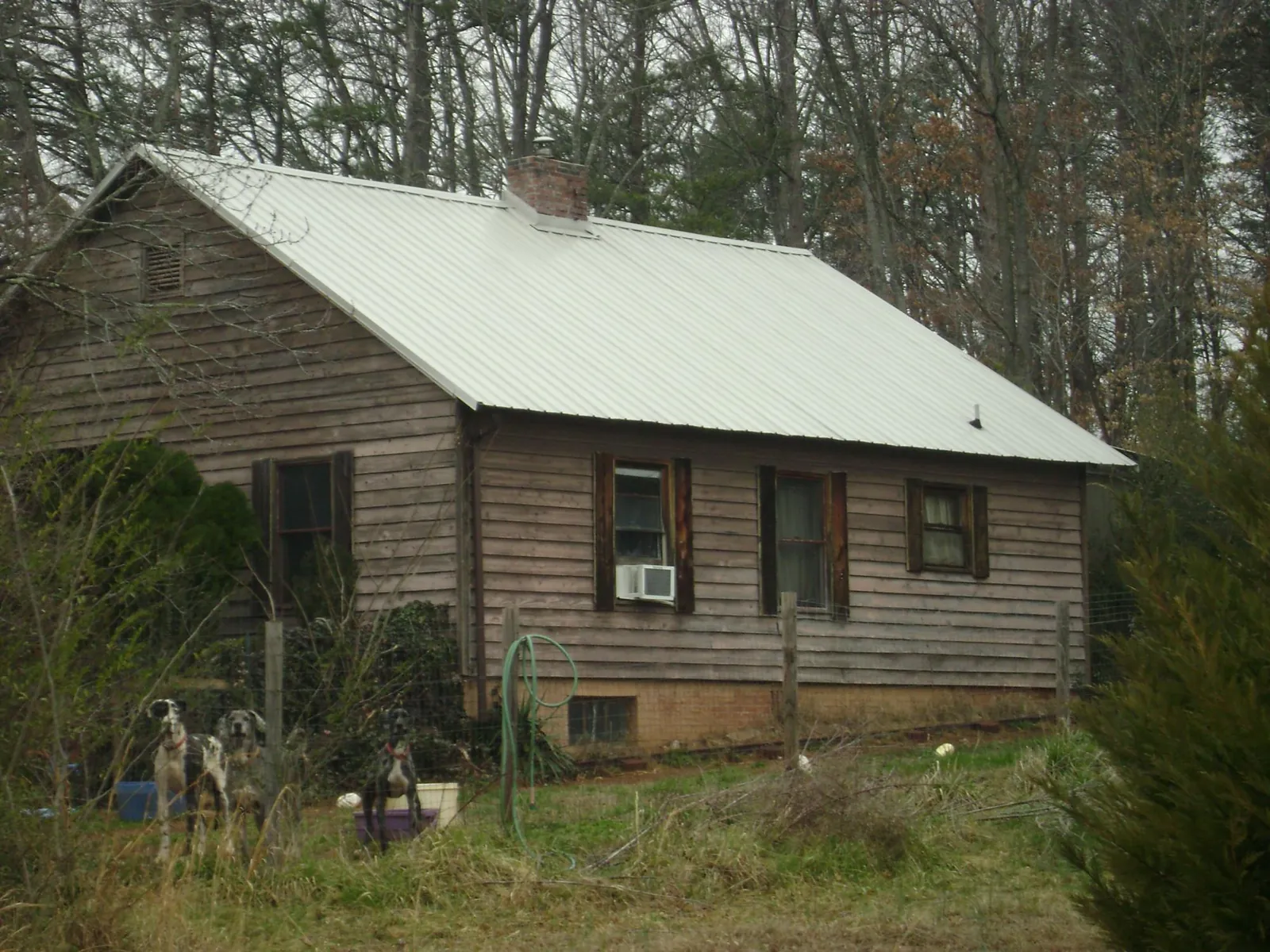 White metal roof on an old wood sided farmhouse, from a Metal Roof Installation job in Searchlight